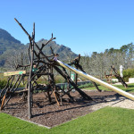 A playground with many wooden sticks and poles.